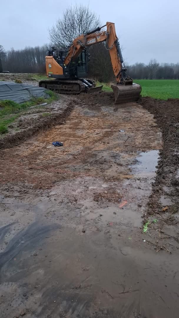 Kraan die grond uitgraaft en nivelleert op een bouwterrein
